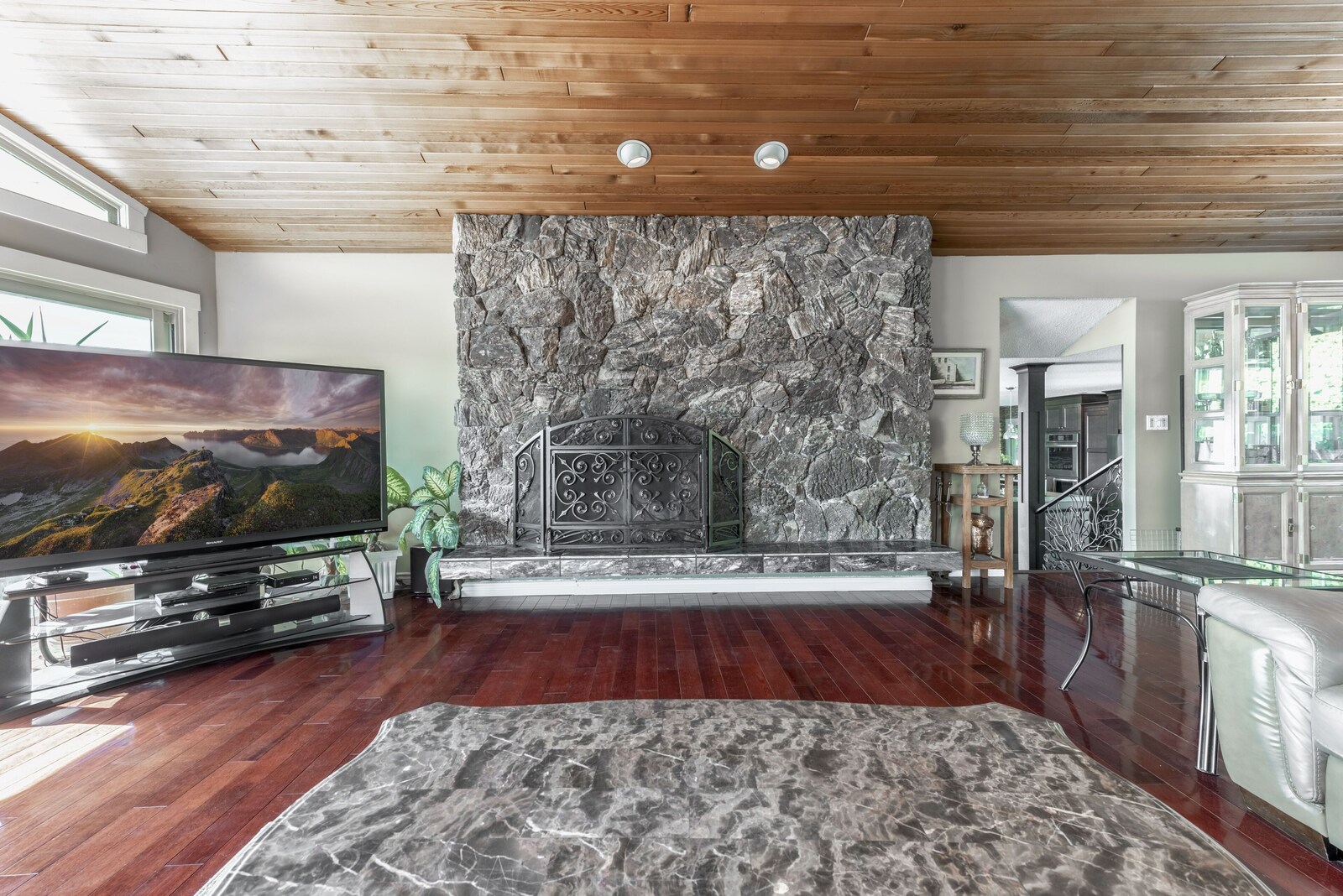 Great room with vaulted wood ceiling and stone fireplace