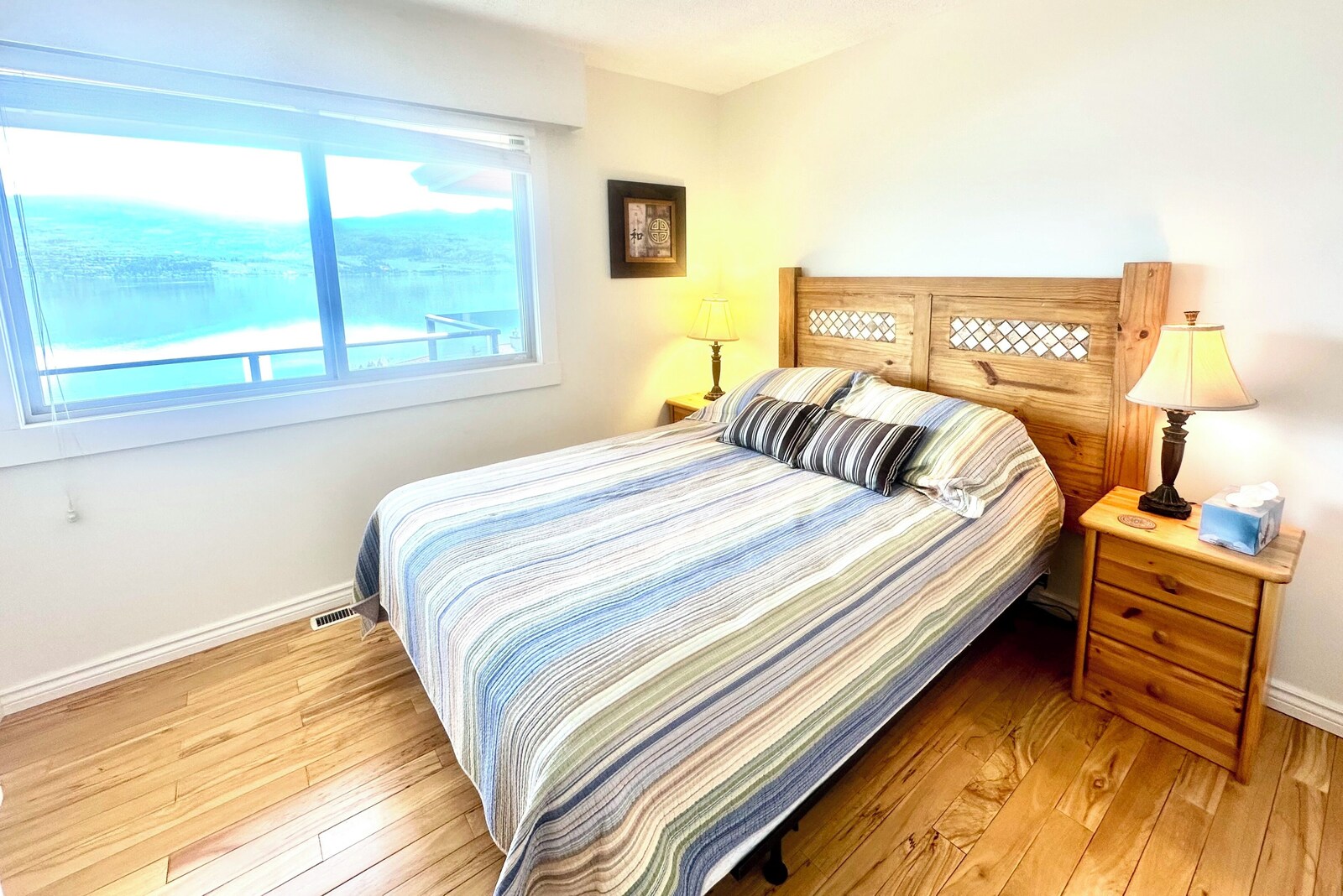 Bedroom with lake view and hardwood floors