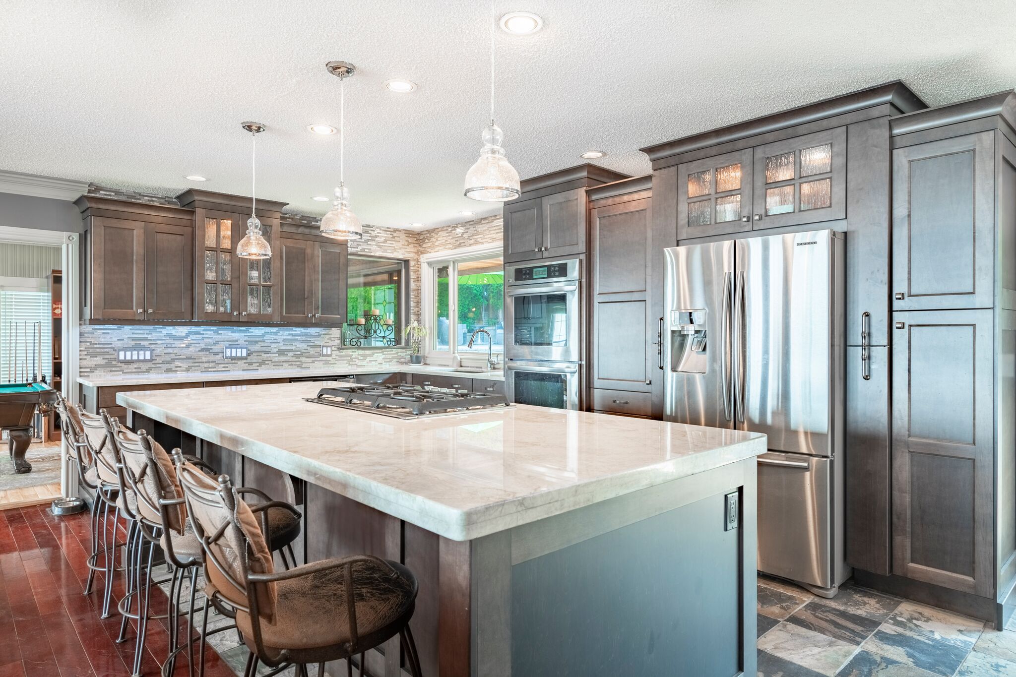 Kitchen island with gas cooktop and bar seating