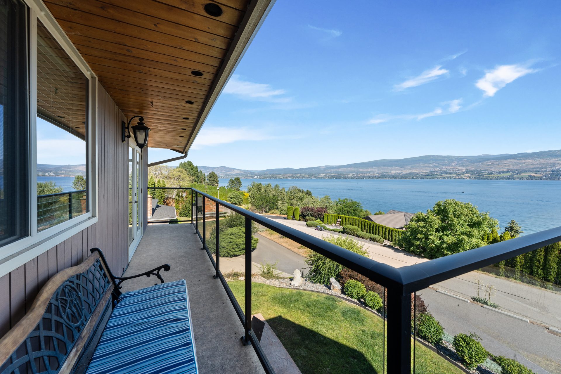 Front balcony bench seating with sweeping Okanagan Lake and mountain view