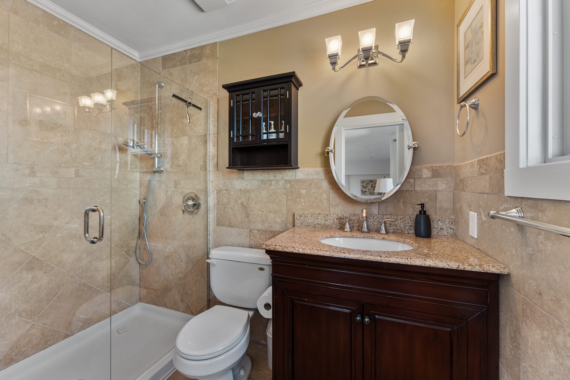 Laundry room with Maytag washer and dryer, stone tile backsplash and dark cabinetry